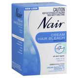 Nair hair bleach cream for face and body product packaging showing new look and dermatologically tested formula.