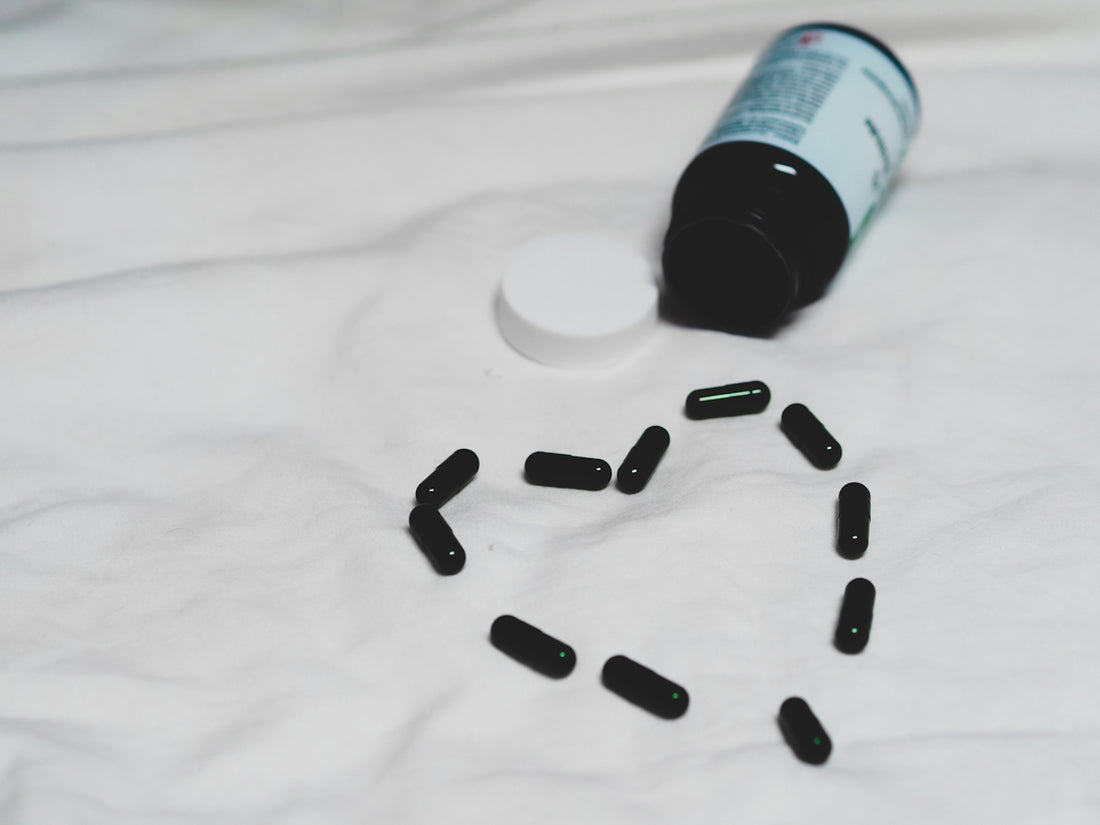 black plastic bottle on white textile