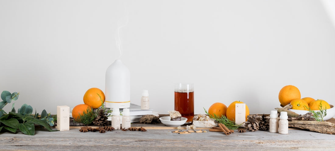 a wooden table topped with oranges and candles