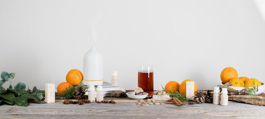 a wooden table topped with oranges and candles