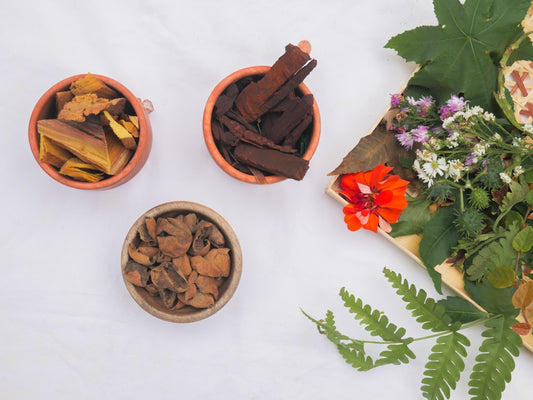 three small bowls filled with different types of flowers
