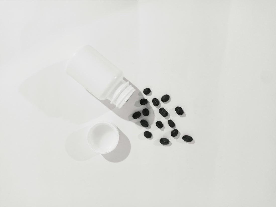 a bottle of pills next to a cup of pills