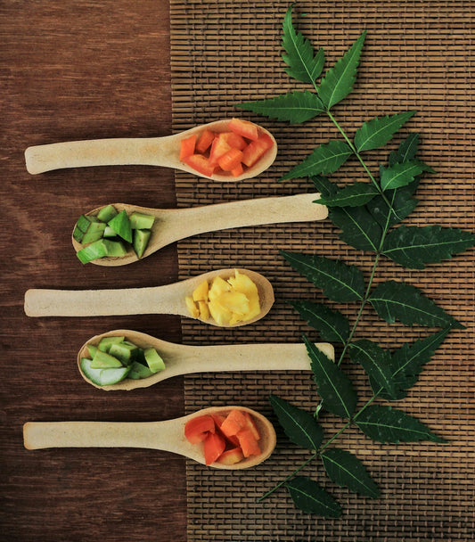 Five wooden spoons filled with different types of food