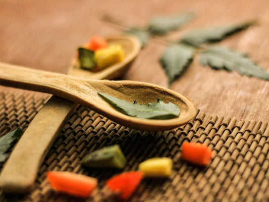 A wooden spoon filled with lots of different colored candy