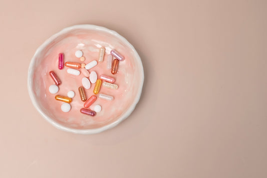 A white bowl filled with pills on top of a table