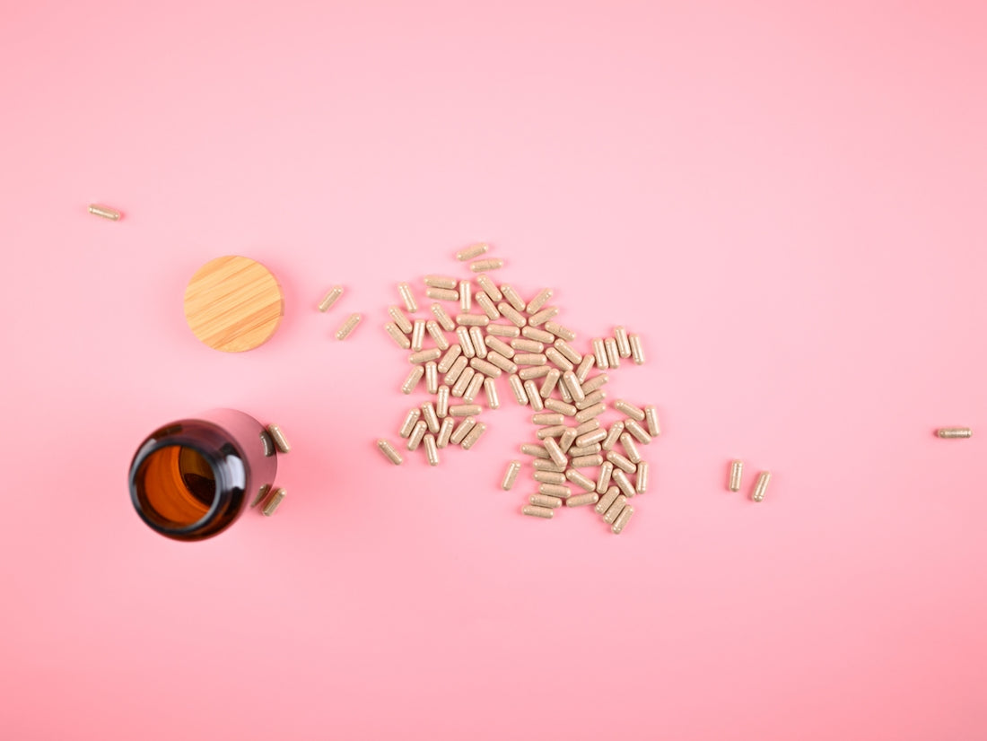 Pile of capsules spilled from a brown bottle